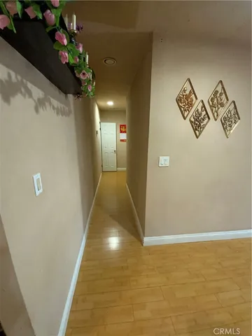 a view of a hallway with wooden floor
