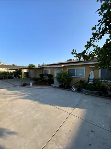 a view of a car park in front of a house