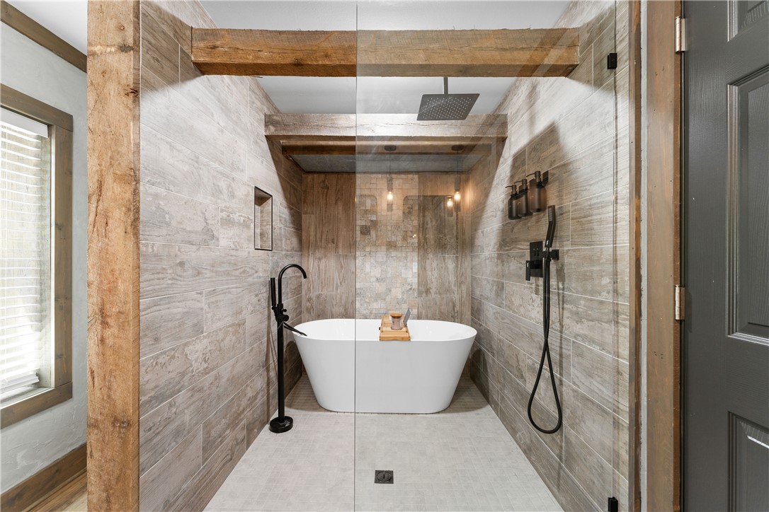 3931 Zack Road Marshall, AR 72650 - Photo 15 of 56 Bathroom featuring a soaking tub, tile walls, and walk in shower