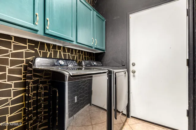 a utility room with a sink a cabinetry and a window