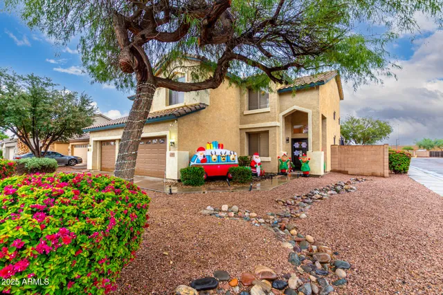 a front view of a house with a yard and fountain