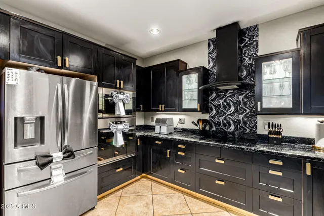 a kitchen with granite countertop a sink stove and refrigerator