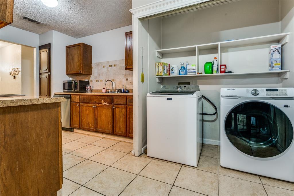 6102 Kelly Elliott Road Arlington, TX 76001 - Photo 5 of 12 a kitchen with stainless steel appliances granite countertop a refrigerator and a sink