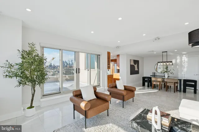 a view of a dining room with furniture a chandelier and wooden floor