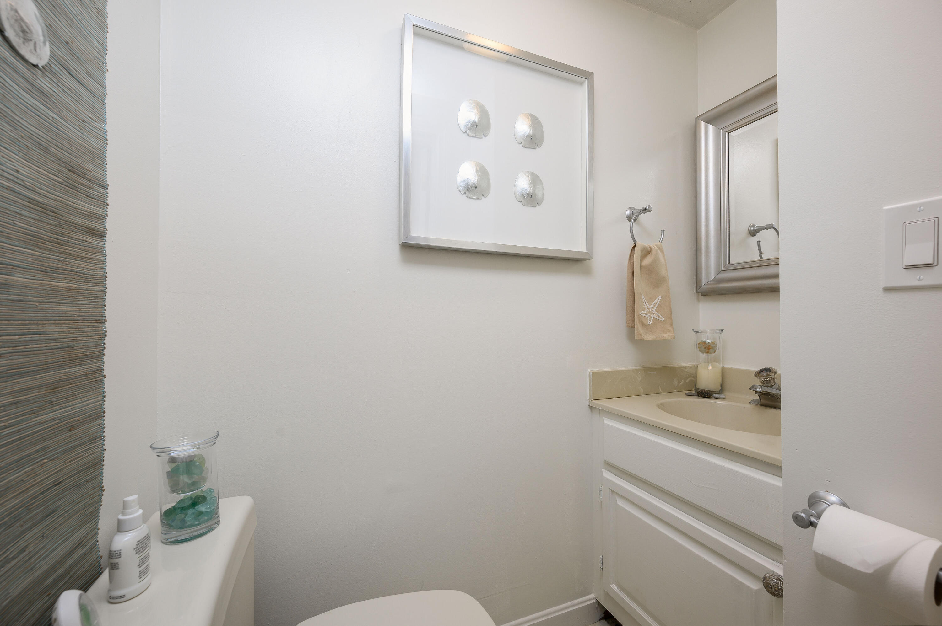 174 Lowell Road, Unit D39 Mashpee, MA 02649 - Photo 16 of 32 a bathroom with a toilet sink and mirror