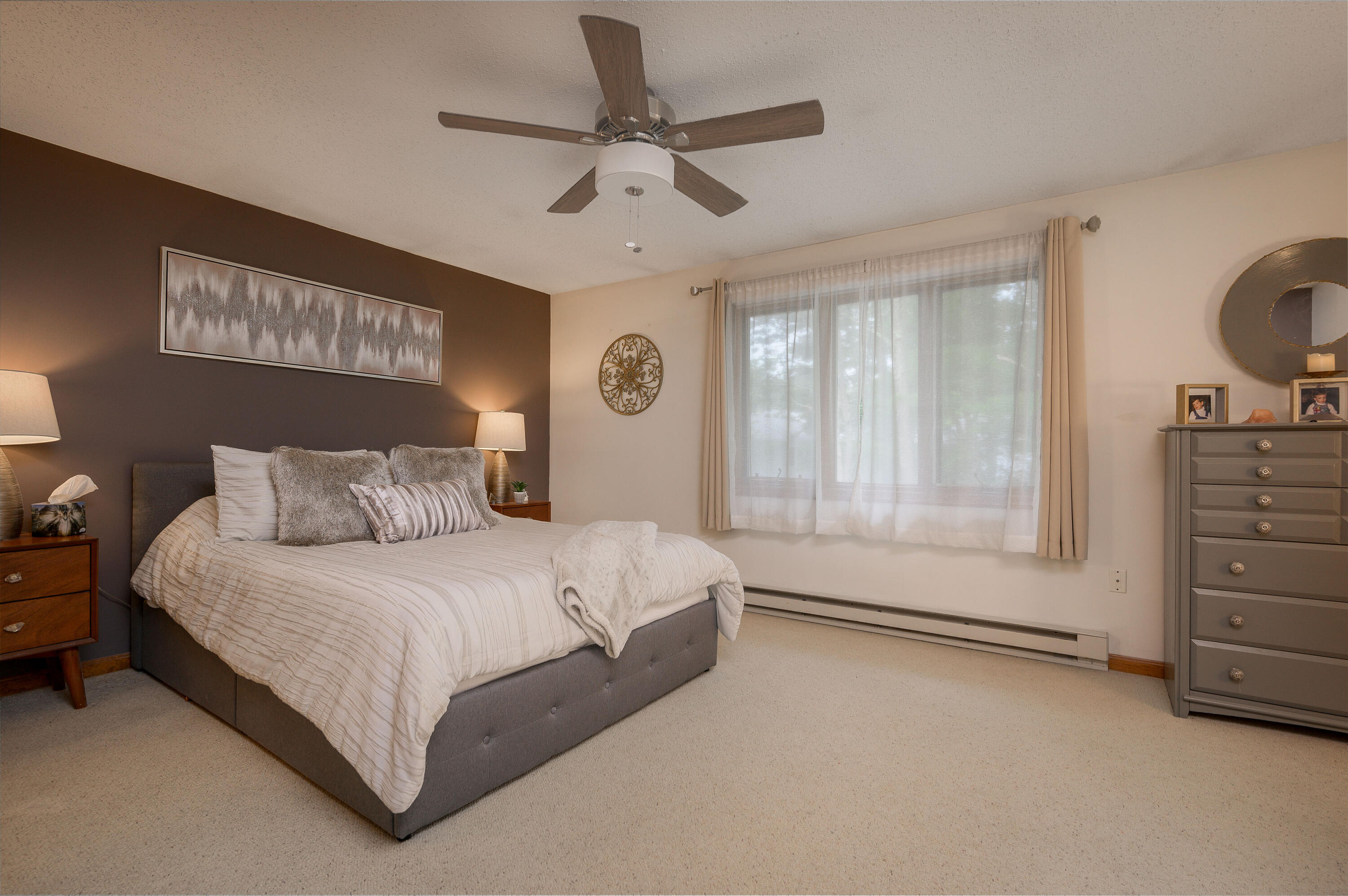 174 Lowell Road, Unit D39 Mashpee, MA 02649 - Photo 17 of 32 a bedroom with a bed a dresser and a window