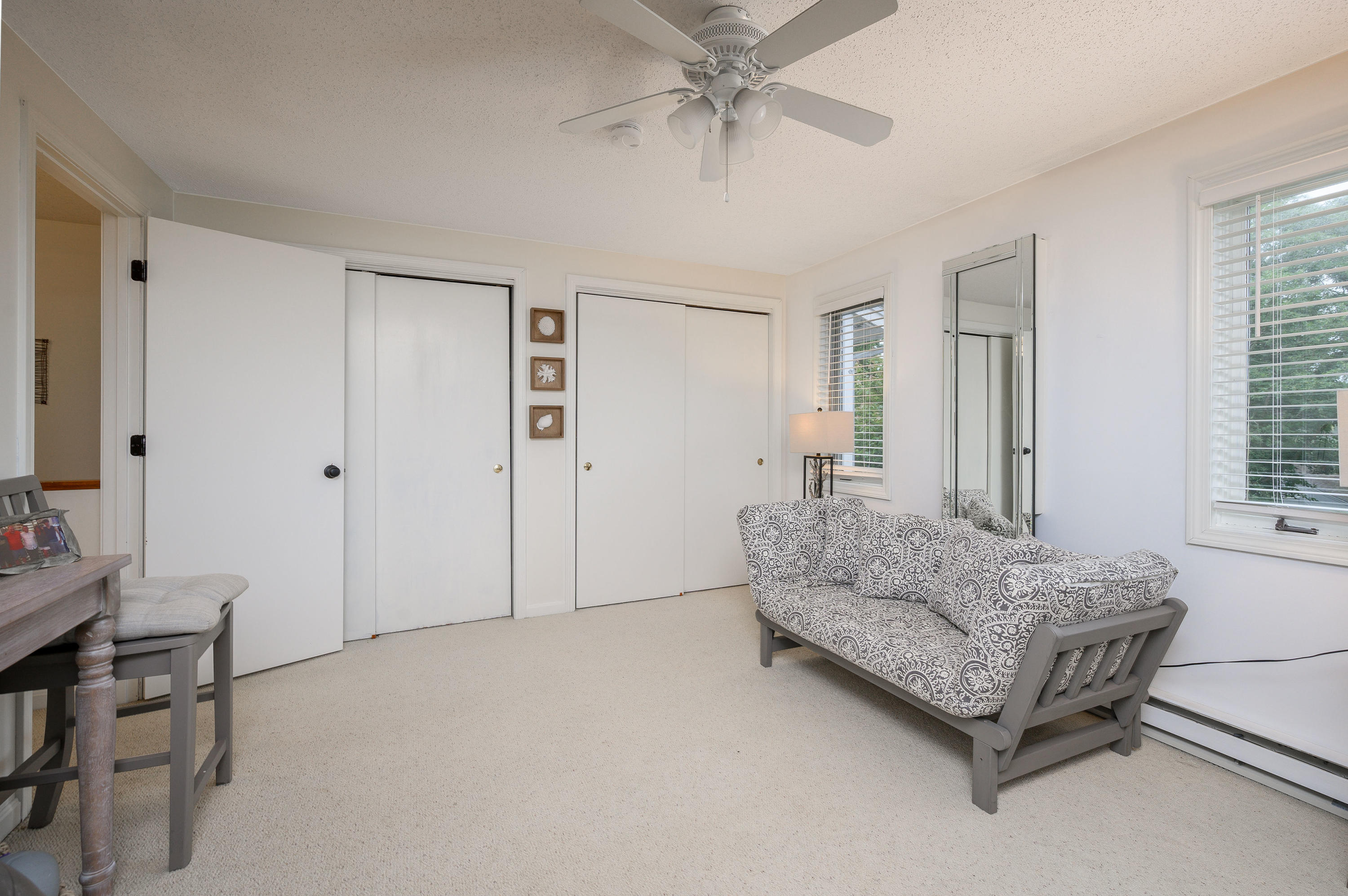 174 Lowell Road, Unit D39 Mashpee, MA 02649 - Photo 23 of 32 a living room with furniture and a chandelier