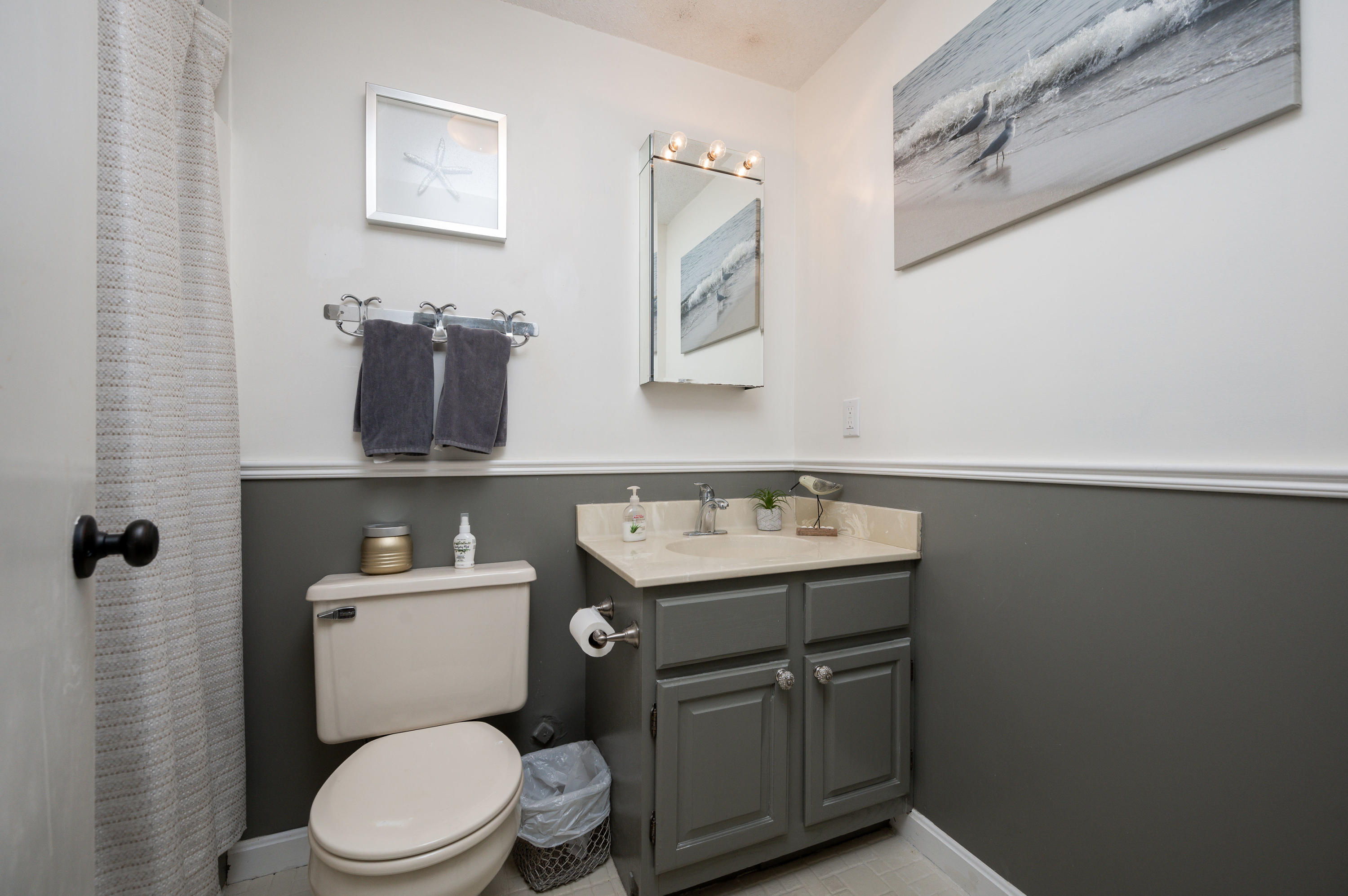 174 Lowell Road, Unit D39 Mashpee, MA 02649 - Photo 26 of 32 a bathroom with a toilet a sink and mirror