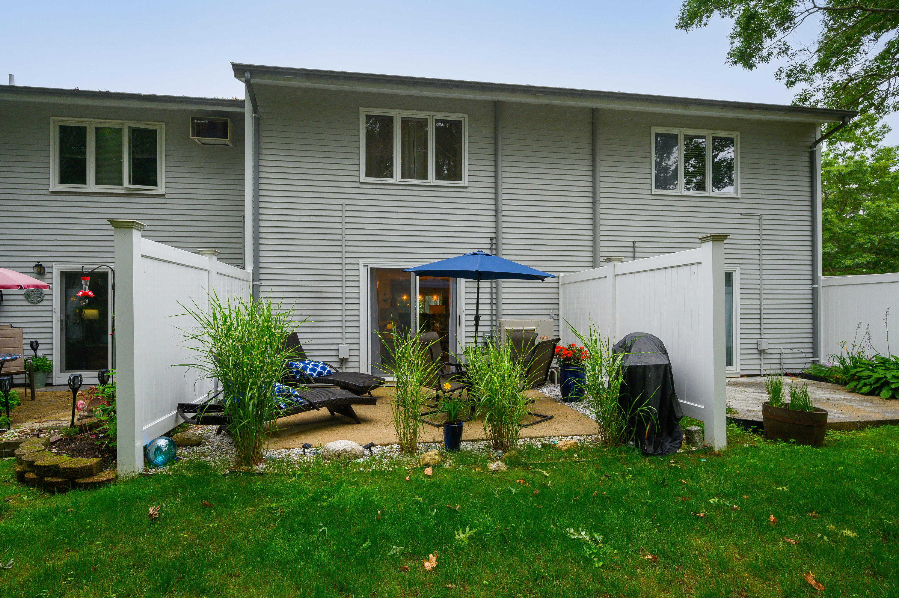 174 Lowell Road, Unit D39 Mashpee, MA 02649 - Photo 29 of 32 a view of house with a yard and sitting area