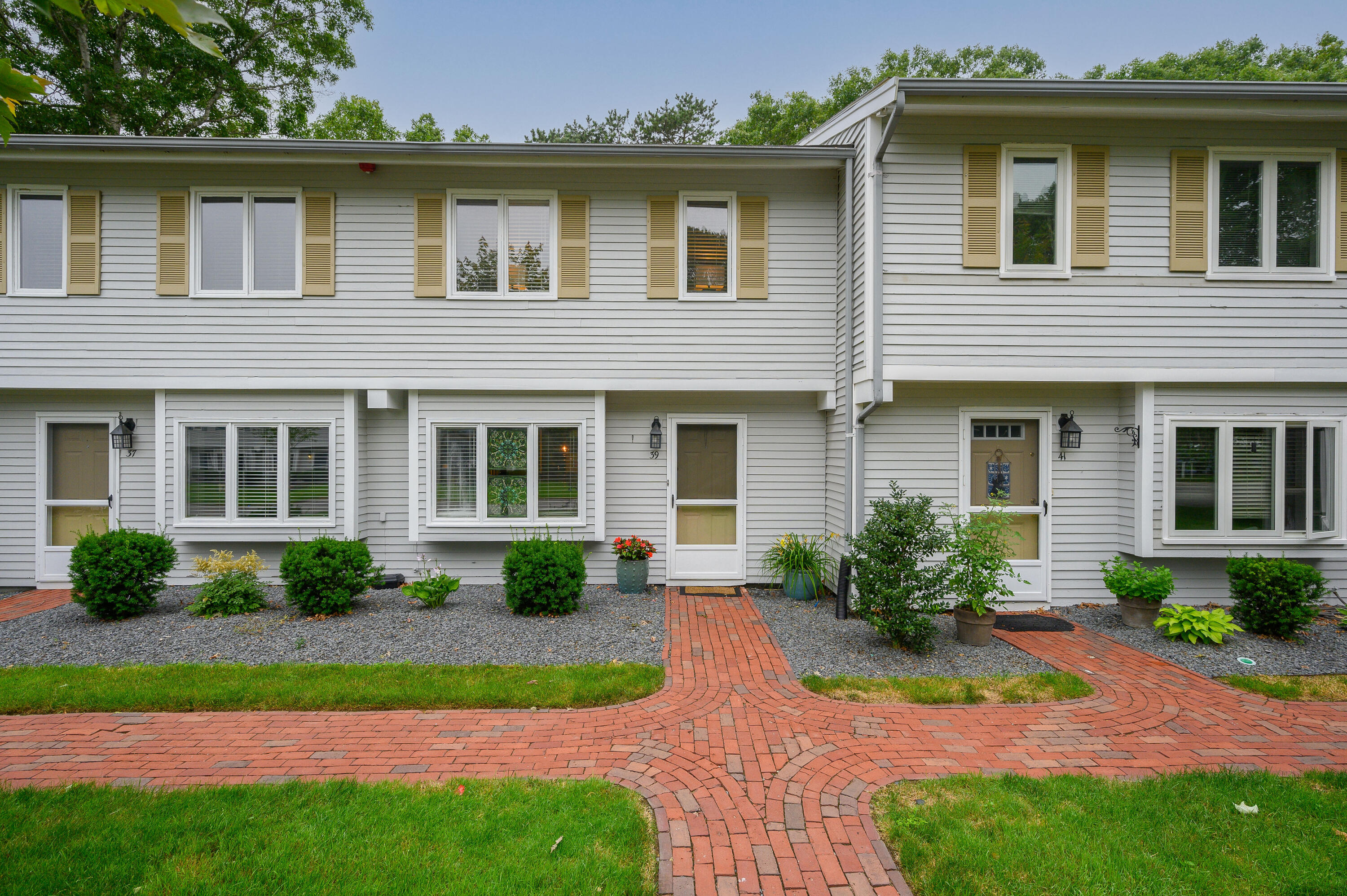 174 Lowell Road, Unit D39 Mashpee, MA 02649 - Photo 32 of 32 a front view of a house with a yard