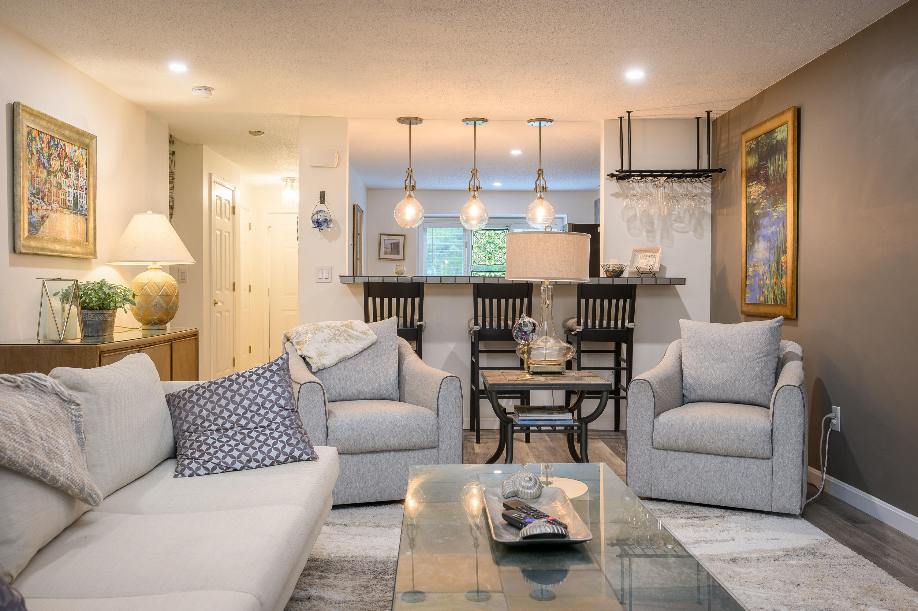 174 Lowell Road, Unit D39 Mashpee, MA 02649 - Photo 6 of 32 a living room with furniture kitchen view and a wooden floor