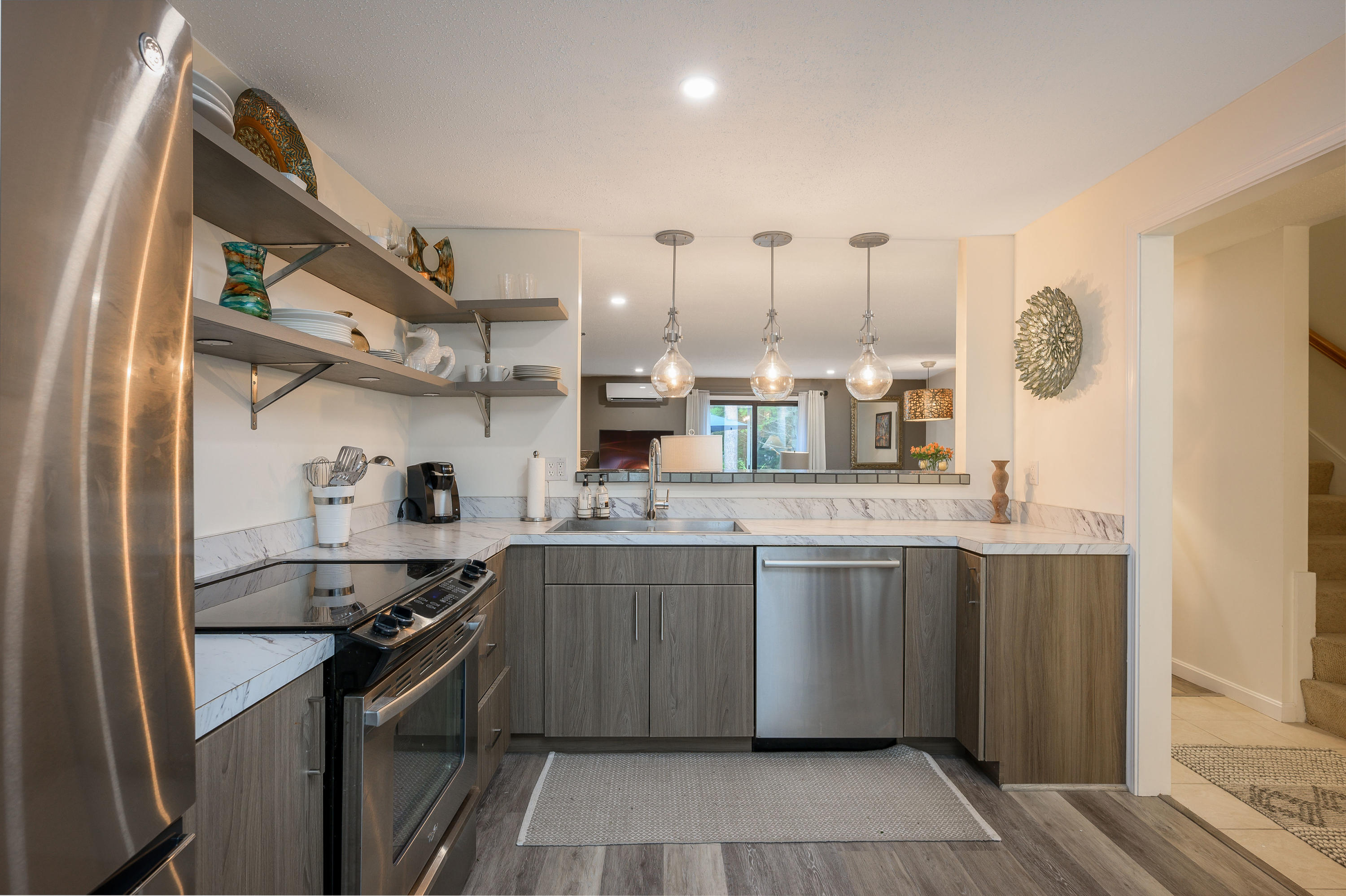 174 Lowell Road, Unit D39 Mashpee, MA 02649 - Photo 8 of 32 a kitchen with stainless steel appliances granite countertop a sink and stove