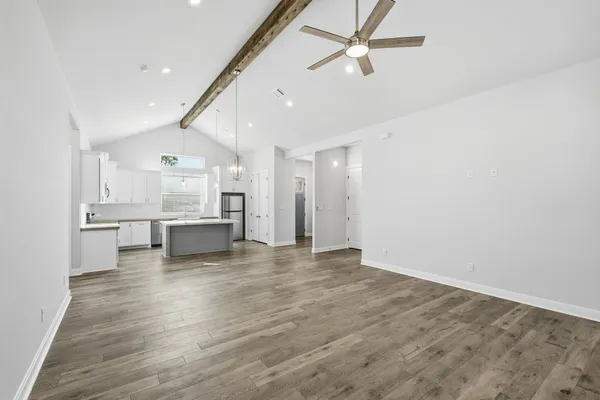 a view of a kitchen with a sink and wooden floor