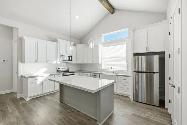 a kitchen with a stove a refrigerator and a sink