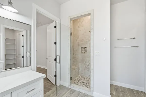 a bathroom with a shower and a sink