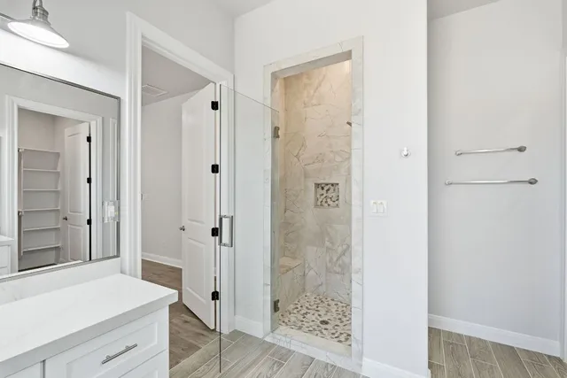 a bathroom with a shower and a sink