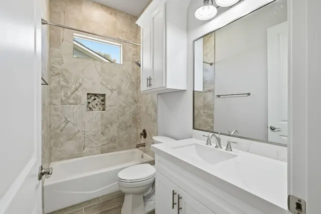 a bathroom with a sink toilet and shower