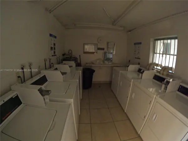 a front view of a house with a garden and plants