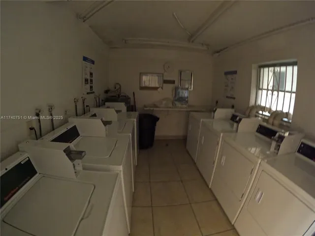 a front view of a house with a garden and plants