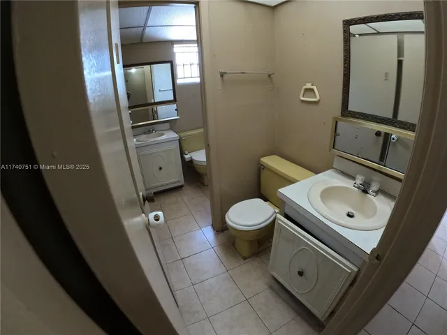 en empty room with windows and fan