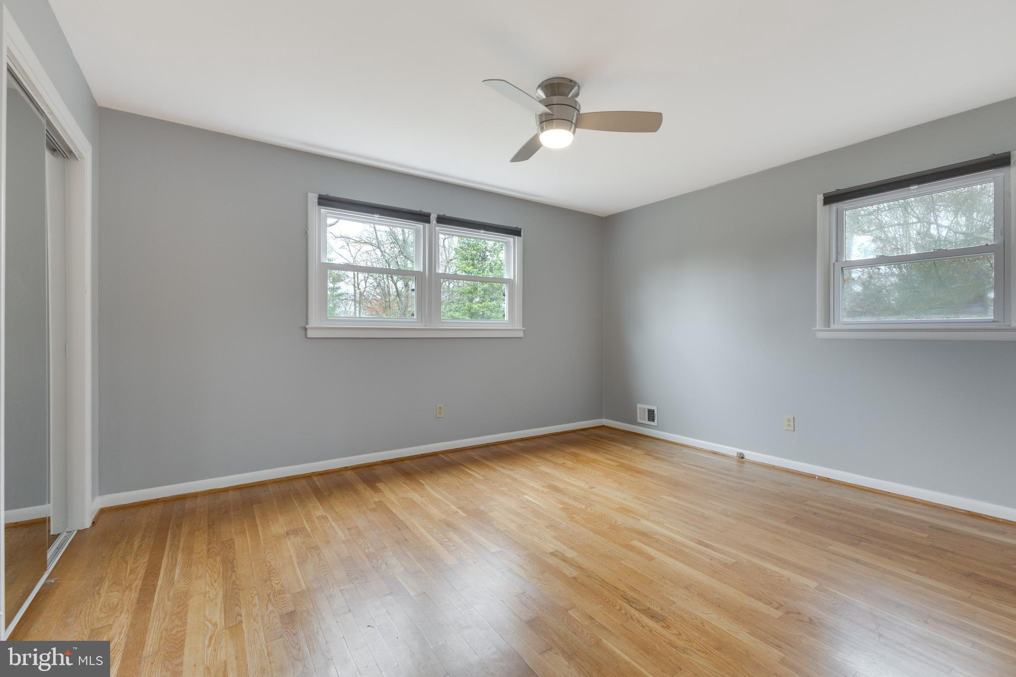 8816 Battery Road Alexandria, VA 22308 - Photo 15 of 25 a view of an empty room with a window and wooden floor