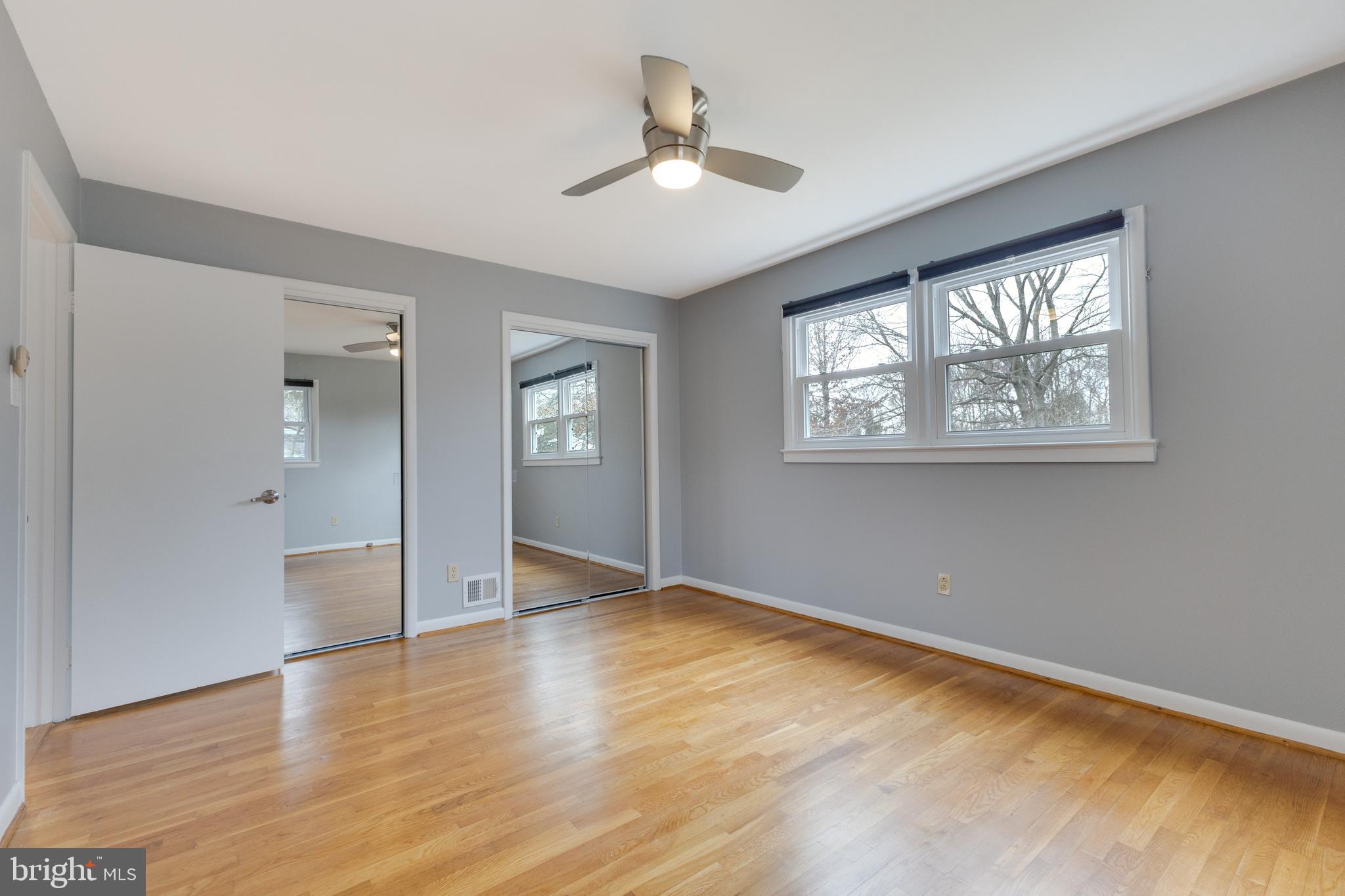 8816 Battery Road Alexandria, VA 22308 - Photo 16 of 25 a view of an empty room with wooden floor and a window