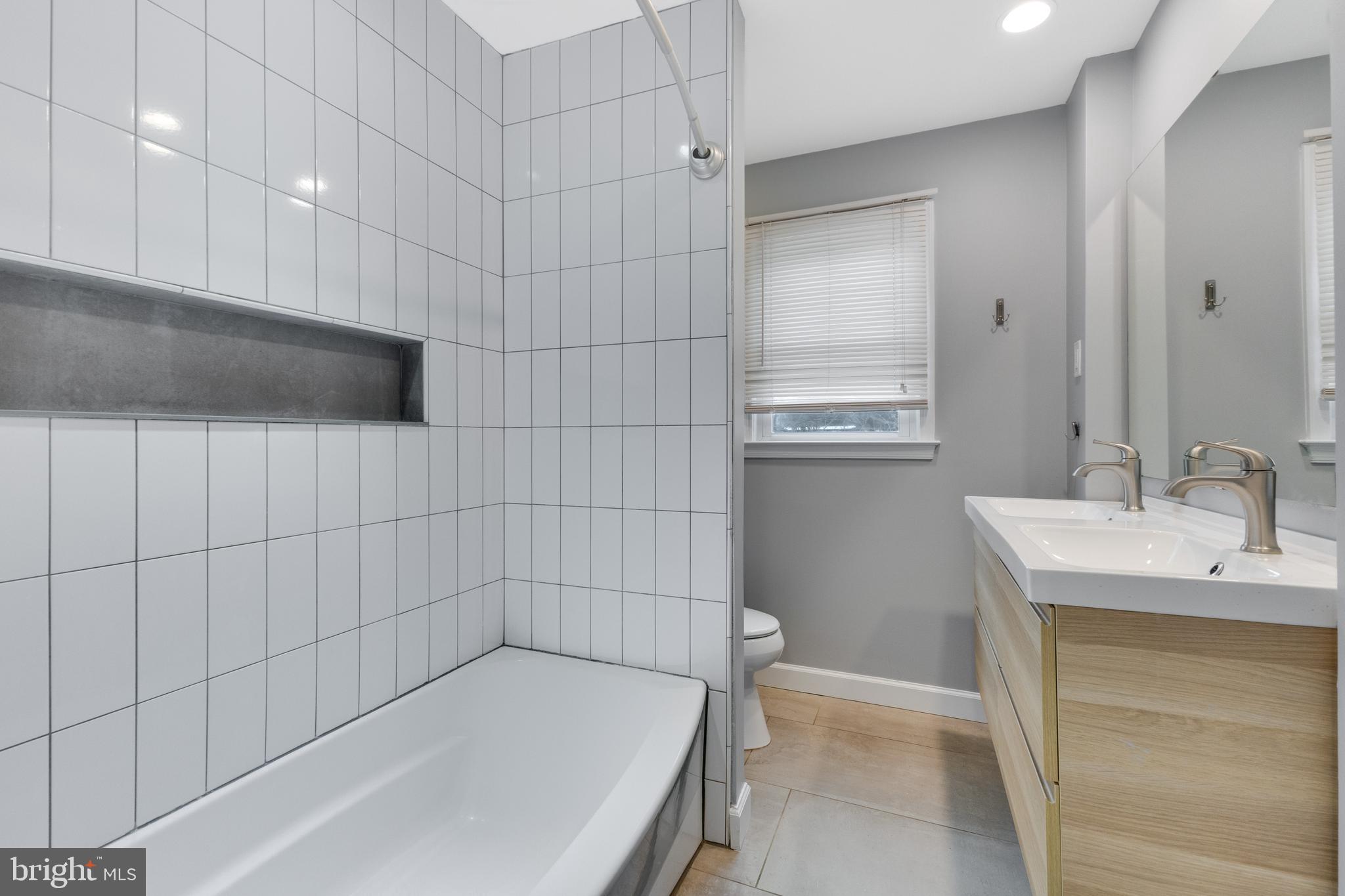 8816 Battery Road Alexandria, VA 22308 - Photo 17 of 25 a bathroom with a bathtub and shower