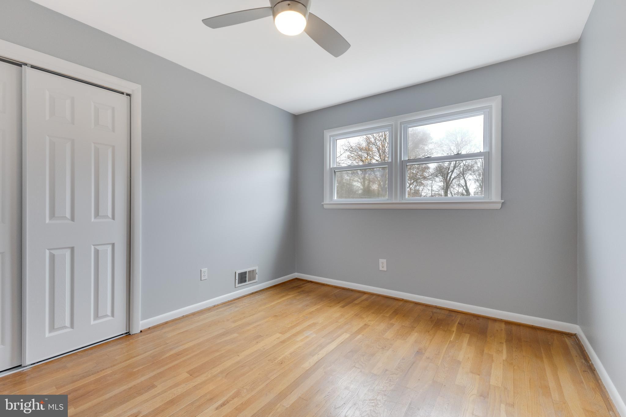 8816 Battery Road Alexandria, VA 22308 - Photo 18 of 25 a view of empty room with wooden floor and fan