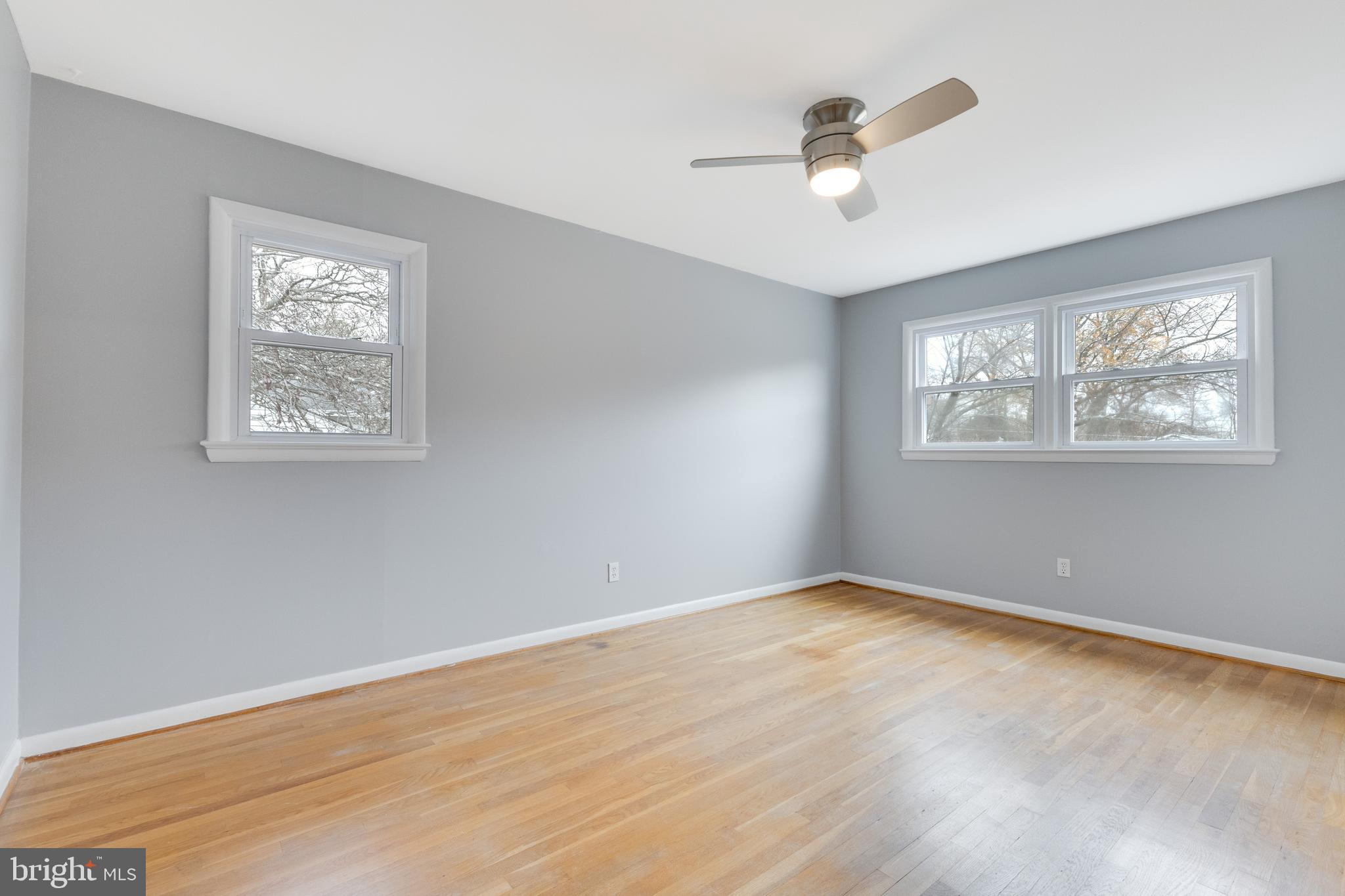 8816 Battery Road Alexandria, VA 22308 - Photo 19 of 25 a view of an empty room with wooden floor and a ceiling fan