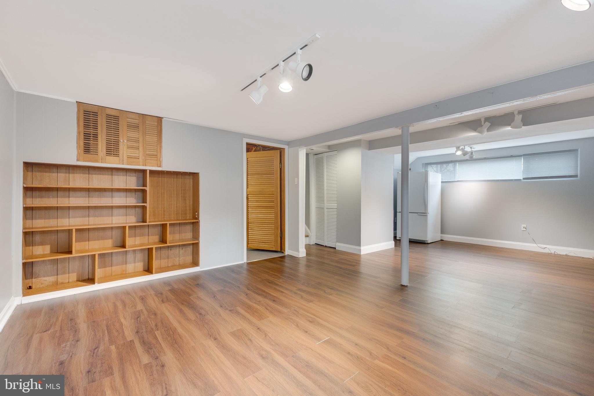 8816 Battery Road Alexandria, VA 22308 - Photo 22 of 25 a view of an empty room with a window and wooden floor