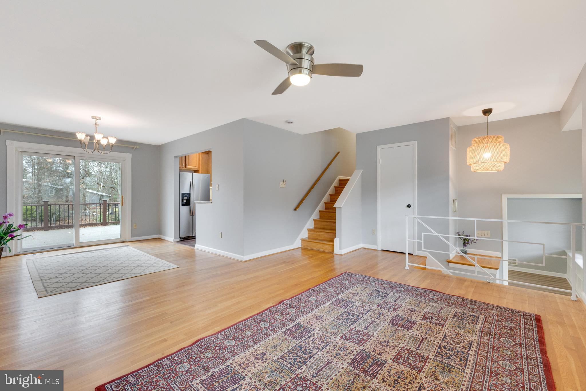 8816 Battery Road Alexandria, VA 22308 - Photo 3 of 25 a view of a livingroom with wooden floor and a ceiling fan
