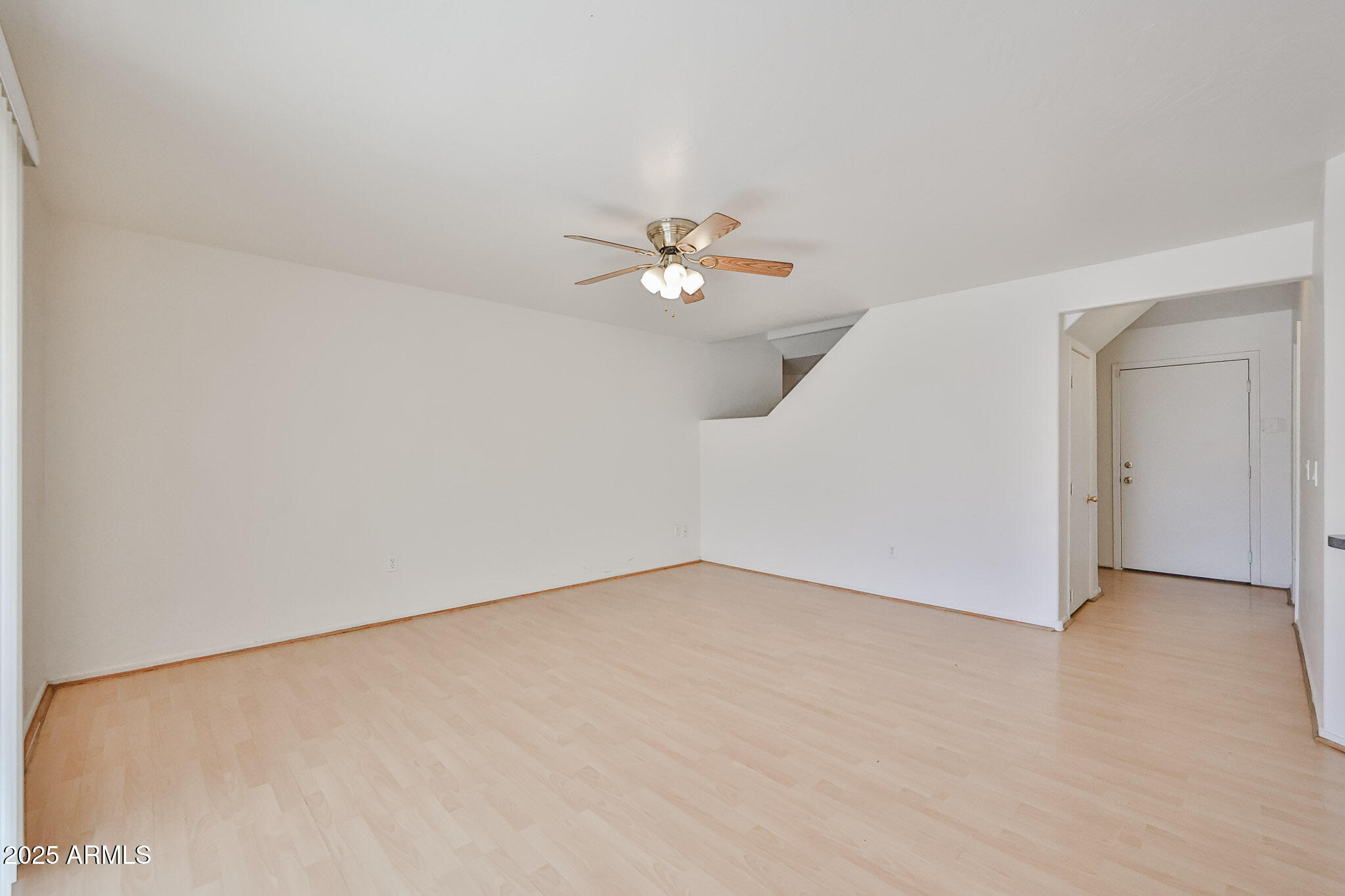 7681 West Lamar Road Glendale, AZ 85303 - Photo 11 of 36 an empty room with a ceiling fan and a window