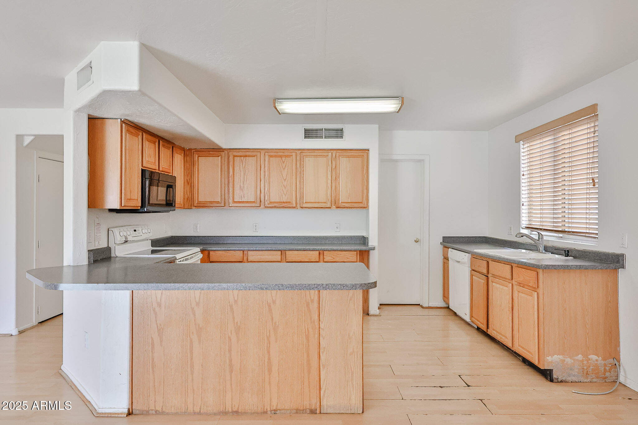 7681 West Lamar Road Glendale, AZ 85303 - Photo 15 of 36 a kitchen with stainless steel appliances granite countertop a stove a sink and a refrigerator