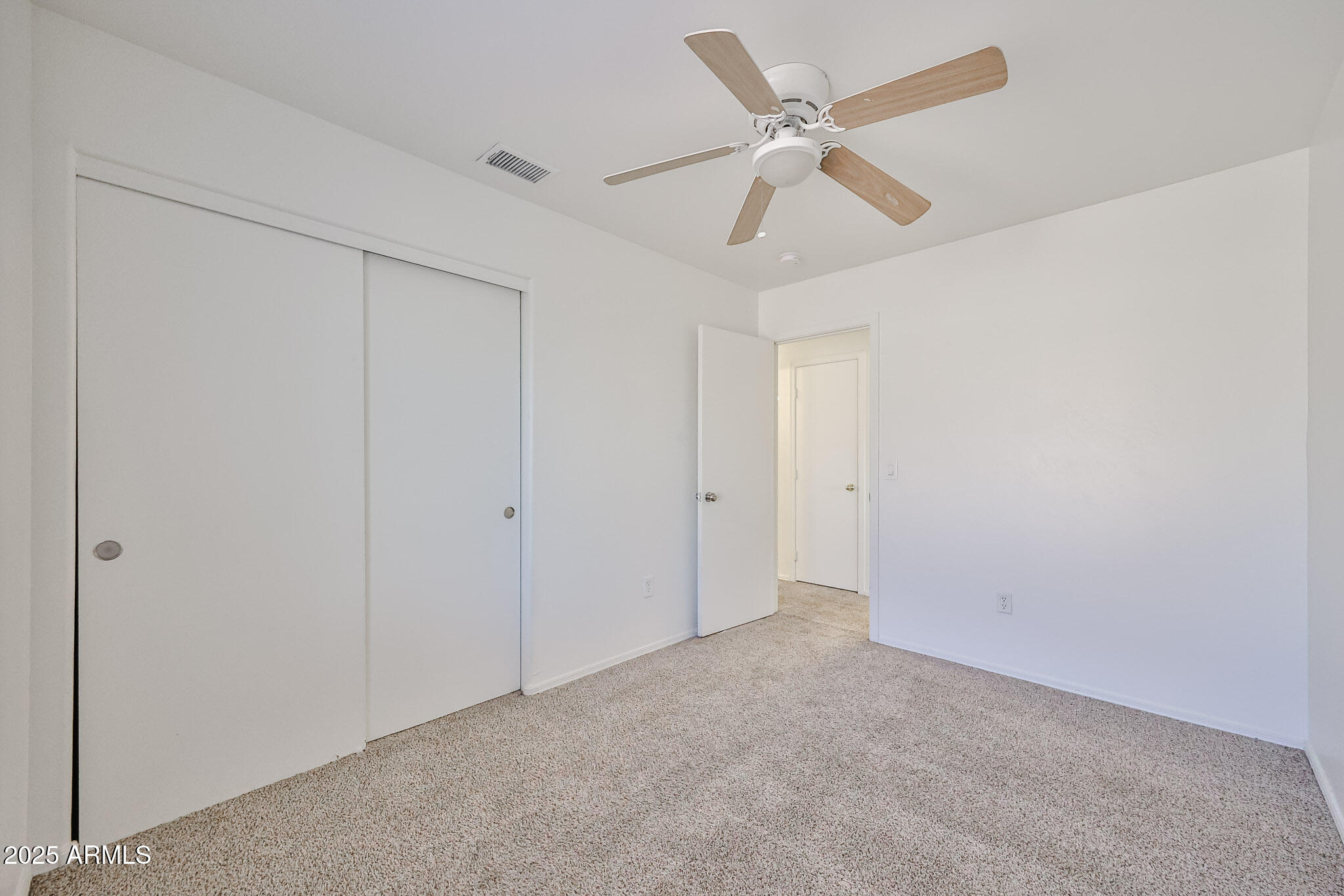 7681 West Lamar Road Glendale, AZ 85303 - Photo 25 of 36 an empty room with a ceiling fan and a ceiling fan