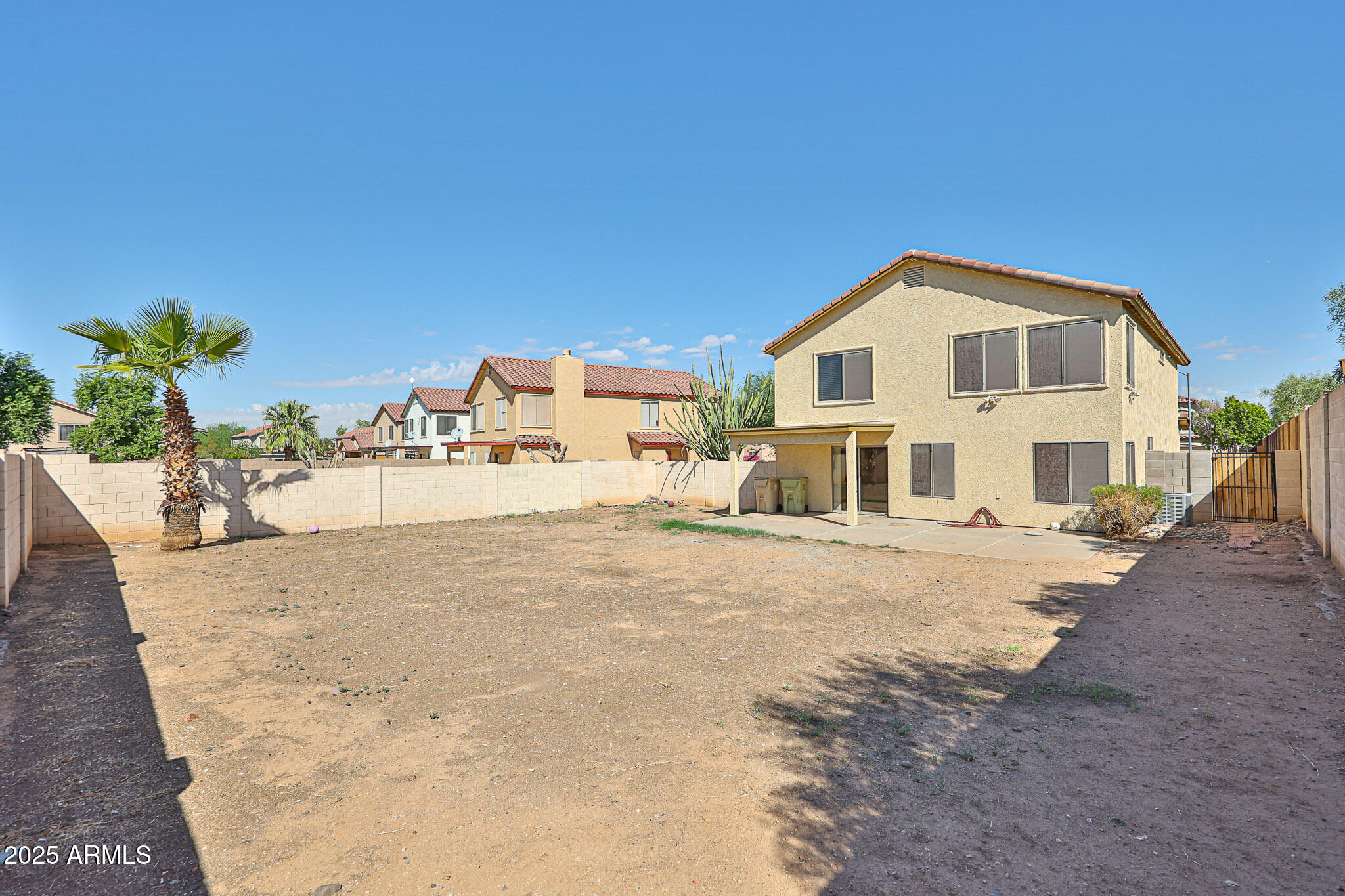 7681 West Lamar Road Glendale, AZ 85303 - Photo 34 of 36 a view of a white house with a yard
