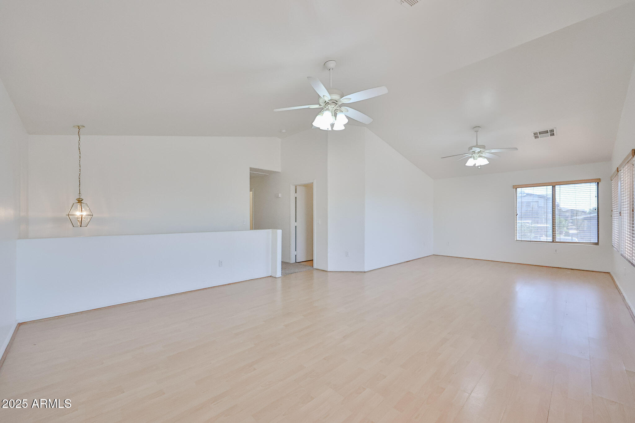 7681 West Lamar Road Glendale, AZ 85303 - Photo 7 of 36 wooden floor in an empty room with a window