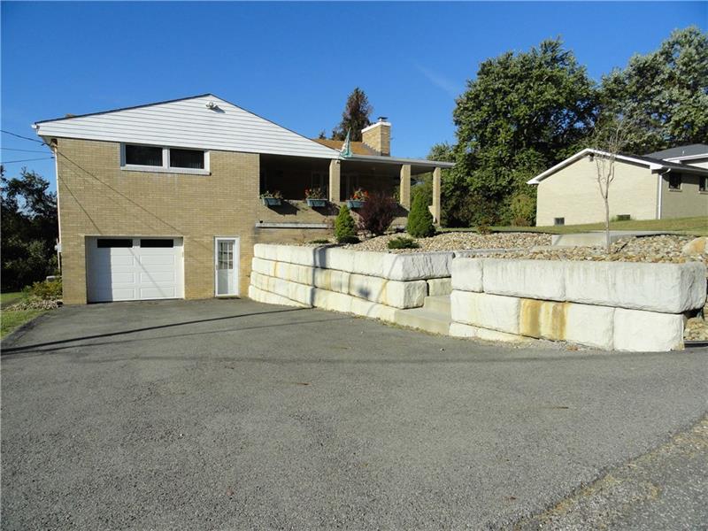 938 Peairs Road Elizabeth, PA 15037 - Photo 25 of 25 Wide driveway, oversized garage with updated door plus man door, updated retaining wall home and is generator ready. Located on a no outlet street on just over half an acre.