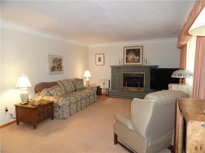 Spanish skip trial plaster & cove ceilings with 8' height, a brick fireplace in the living room, original woodwork & hardwood floors under carpet