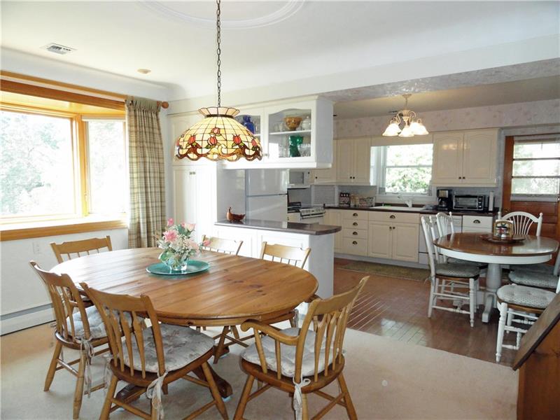 Spacious dining room with cove ceiling, beautiful plaster work and Bay window