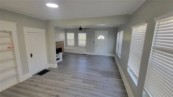 a view of a hallway with wooden floor