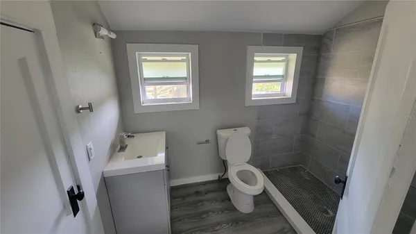 a bathroom with a toilet and a shower