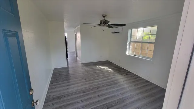 wooden floor in an empty room with a window