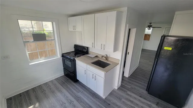 a kitchen with wooden floor and window