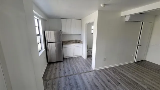 a kitchen with a refrigerator a microwave and stove