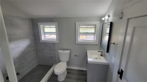 a bathroom with sink toilet and shower