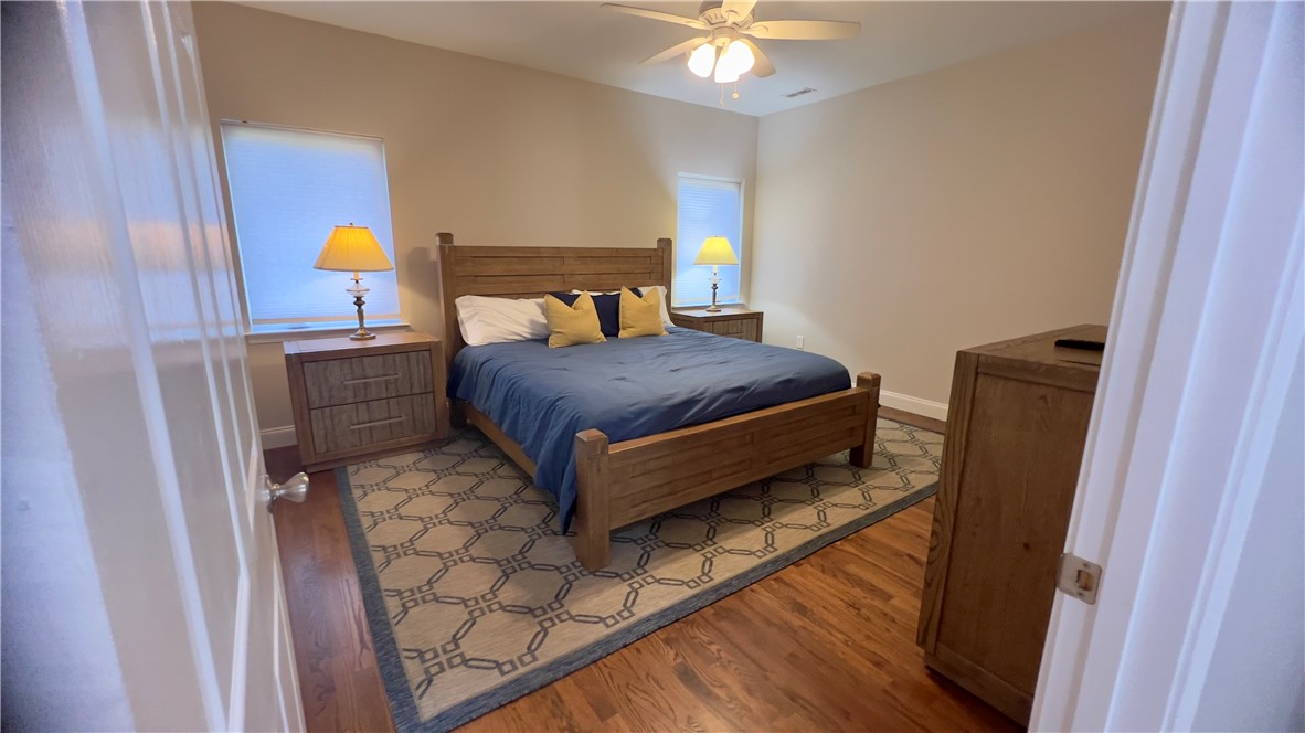 160 Hudgins Lake Road Townville, SC 29689 - Photo 16 of 41 Hardwood floors and a vaulted ceiling elevate this primary bedroom's peaceful retreat.