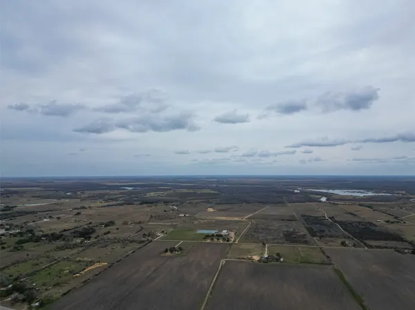 a view of a field with an ocean