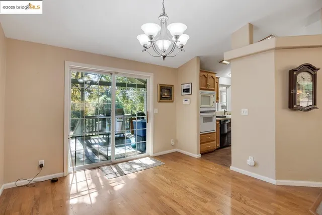 a view of a big room with wooden floor and windows