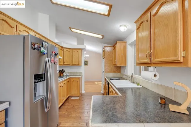 a kitchen with refrigerator and cabinets