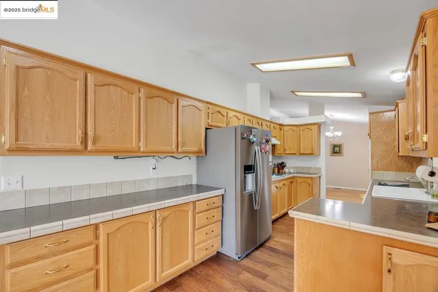 a kitchen with refrigerator cabinets and a sink